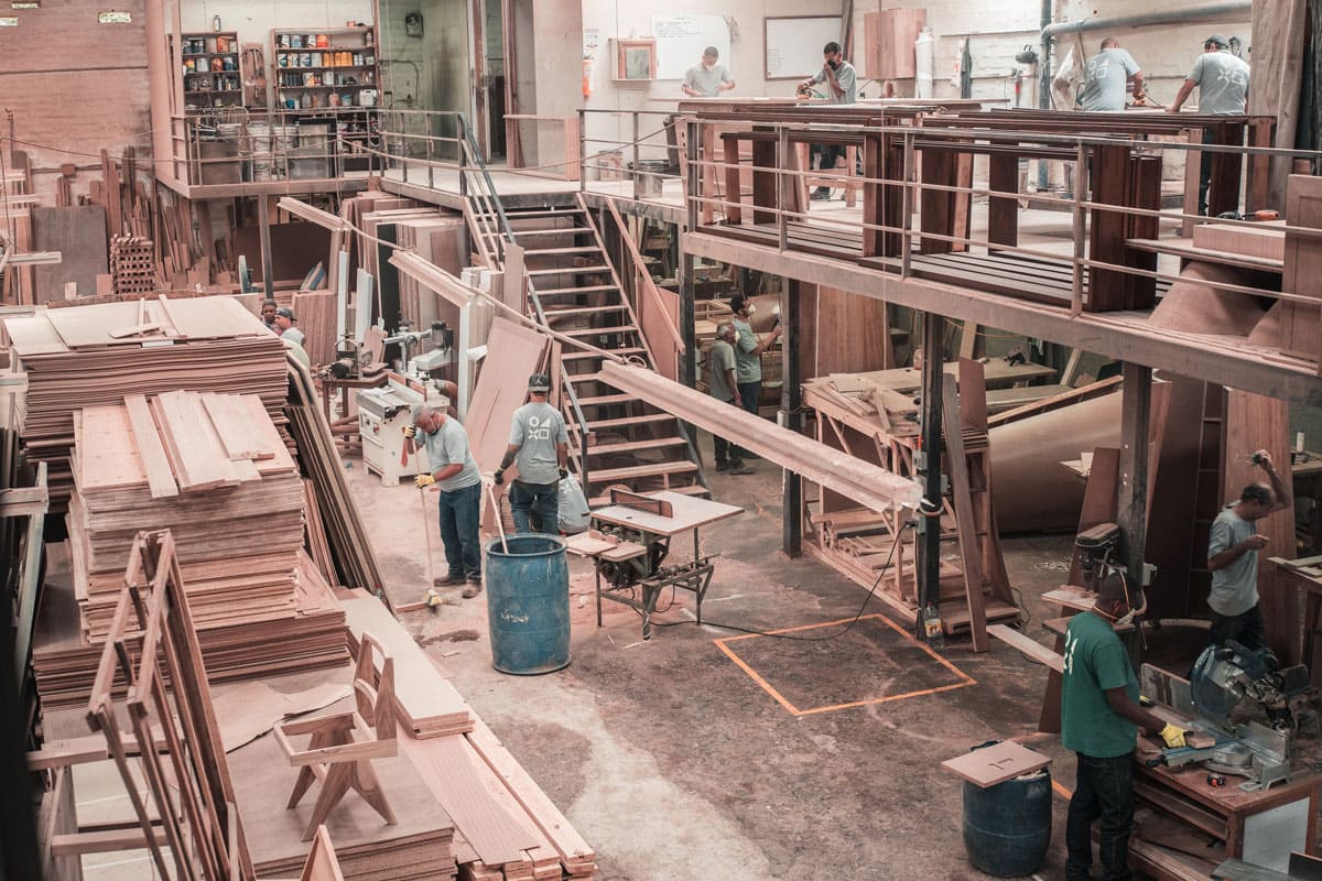 Workers in blue uniform performing physical manufacturing.